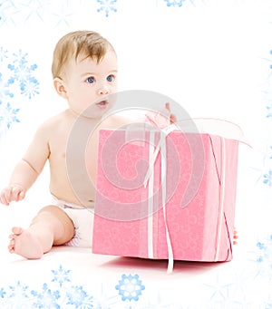 Baby boy in diaper with big gift box