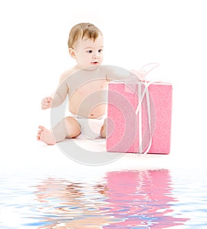 Baby boy in diaper with big gift box