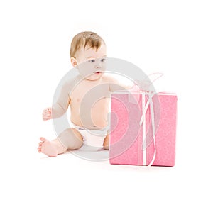 Baby boy in diaper with big gift box