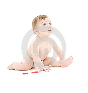 Baby boy in diaper with toothbrush