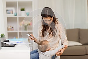 Baby boy disturbing mother working at home