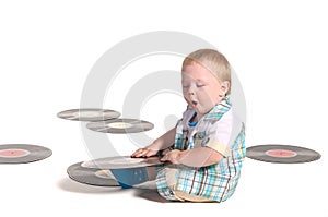 Baby boy DJ playing with vynil disks