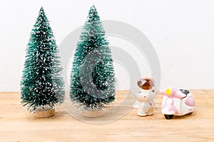 Baby boy doll and motorbike with chrismast trees background