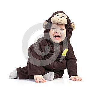 Baby boy dressed in monkey costume over white