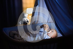 Baby boy drinking milk in bed