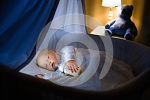 Baby boy drinking milk in bed