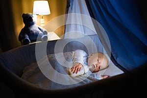 Baby boy drinking milk in bed