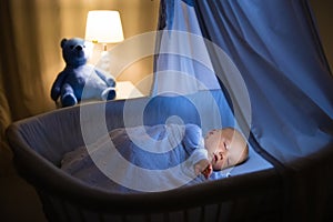 Baby boy drinking milk in bed