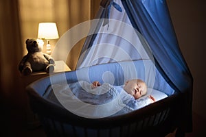 Baby boy drinking milk in bed