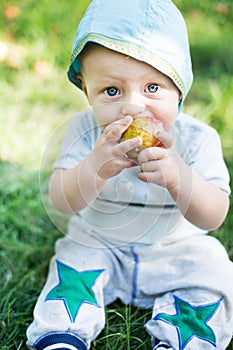 Baby boy eating apple