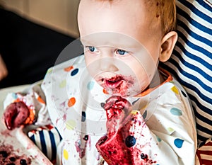 Baby boy eating blueberries