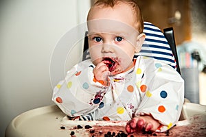 Baby boy eating blueberries