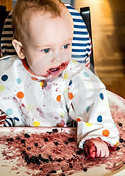 Baby boy eating blueberries