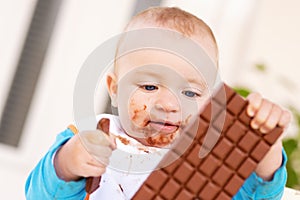 Baby boy eating chocolate