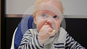 Baby boy eating lemon