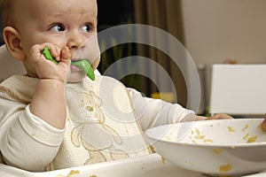 Baby boy eats dinner photo