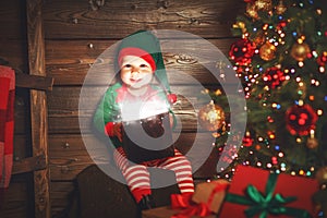 Baby boy elf helper of Santa with a magic Christmas gift