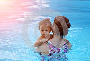 Baby boy first time in a swimming pool
