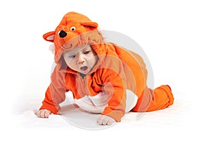 Baby boy in fox costume looking down with surprise