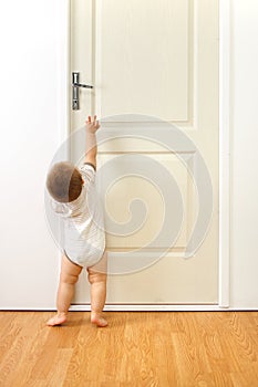 Baby boy in front of door