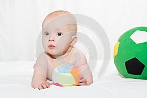 Cute baby girl lying down on his belly