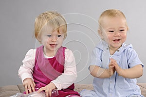 Baby boy and girl playing