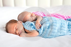 Baby boy and girl twins in bed