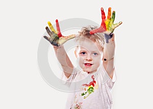 The baby boy with gouache soiled hands and shirt isolated