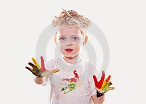 The baby boy with gouache soiled hands and shirt isolated