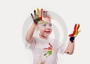 The baby boy with gouache soiled hands and shirt isolated