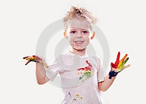 The baby boy with gouache soiled hands and shirt isolated