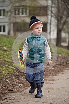 Baby boy in green jaket and blue jeans