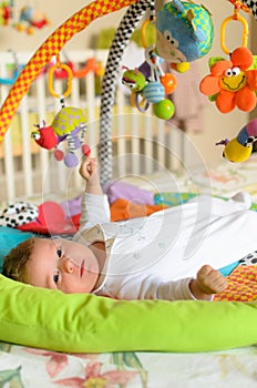 Baby boy with hanging toys