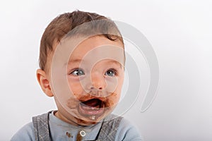 Baby boy happy after eating chocolate