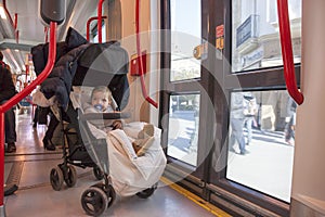 Baby boy having fun during a ride at streetcar, Spain