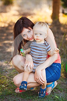 Baby boy with his mum in the park