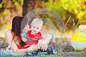 Baby boy with his mum in the park