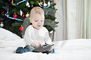 Baby boy holding RC controller at christmas time