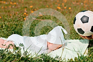 Baby boy infant fun photoshoot soccer football concept big smile having fun playing laughing laying on white furry round through s
