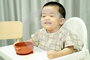 Baby boy joying and smile with dirty face and tartan apron