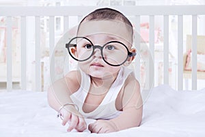 Baby boy lying on bedroom