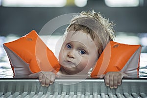 Baby boy makes face in a swiming pool