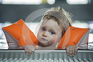 Baby boy makes face in a swiming pool photo