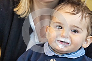 Baby boy with milk mustache making funny faces