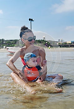 Baby boy and mother at the beach