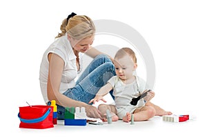 Baby boy and mother play together with toys