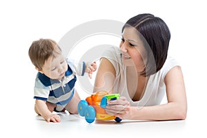 Baby boy and mother playing together with toy