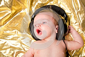 Baby boy with music from headphones