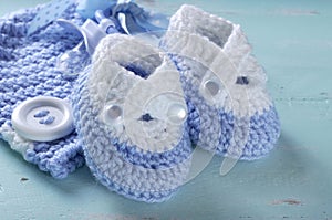 Baby boy nursery blue and white wool booties close up