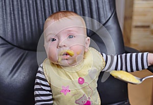 Baby Boy on Office Chair Eating Porridge